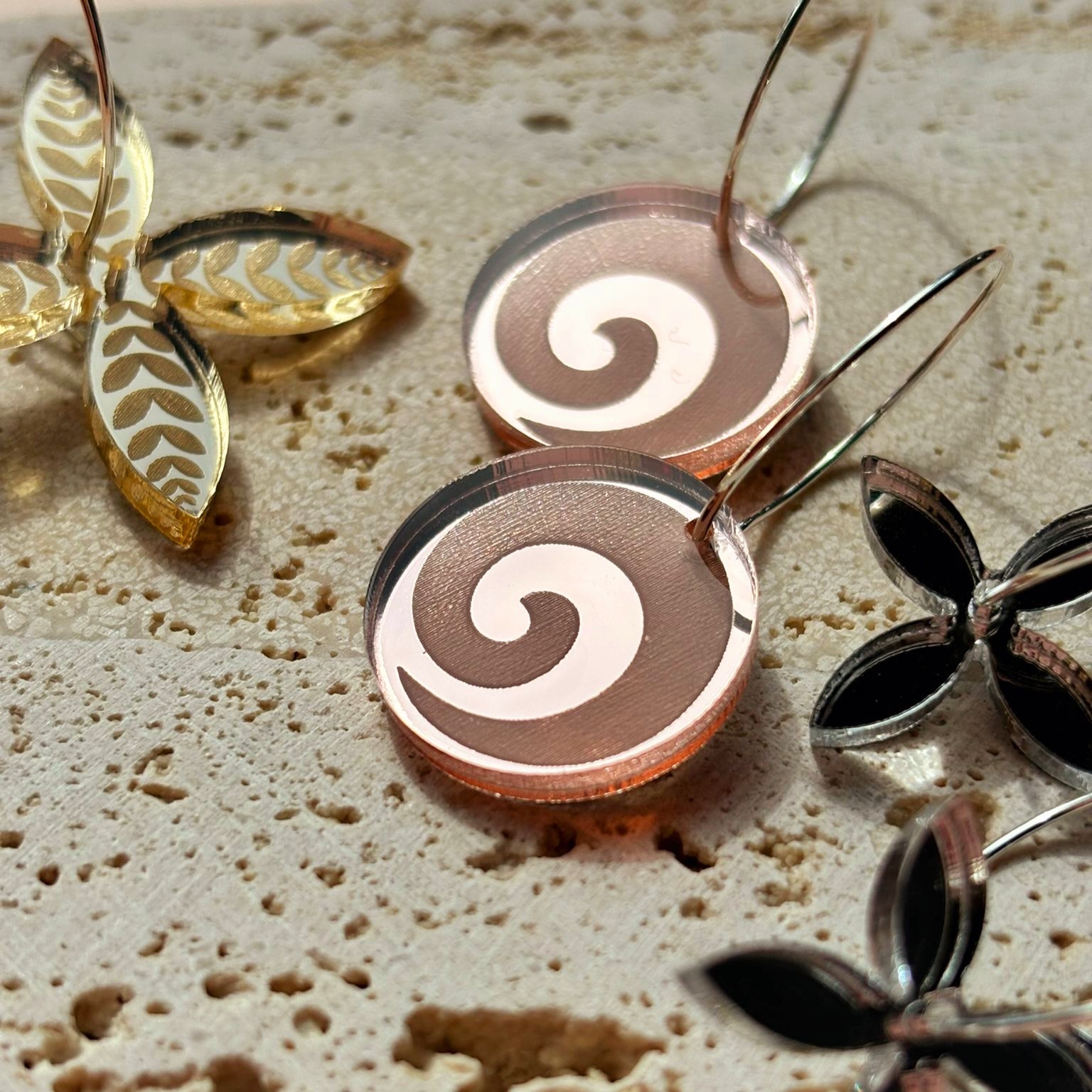 SONZ laser-engraved earrings displayed in a gift box